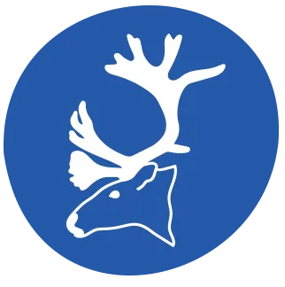 A white silhouette of a reindeers head with antlers inside a solid blue circle.