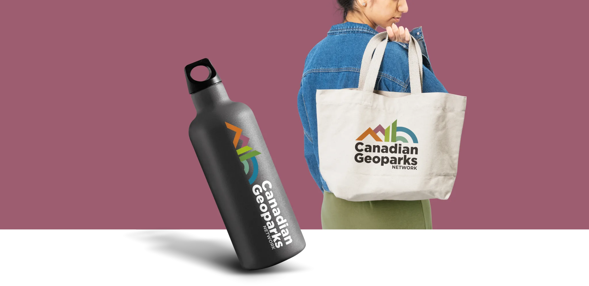 A person with a denim jacket carries a canvas tote bag with the Canadian Geoparks Network logo. Beside them, a black water bottle also displays the same colorful logo on a plain background.