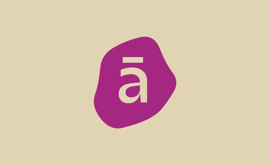 A lowercase letter a with a macron above it, displayed in white on a purple, irregular blob shape, set against a beige background.