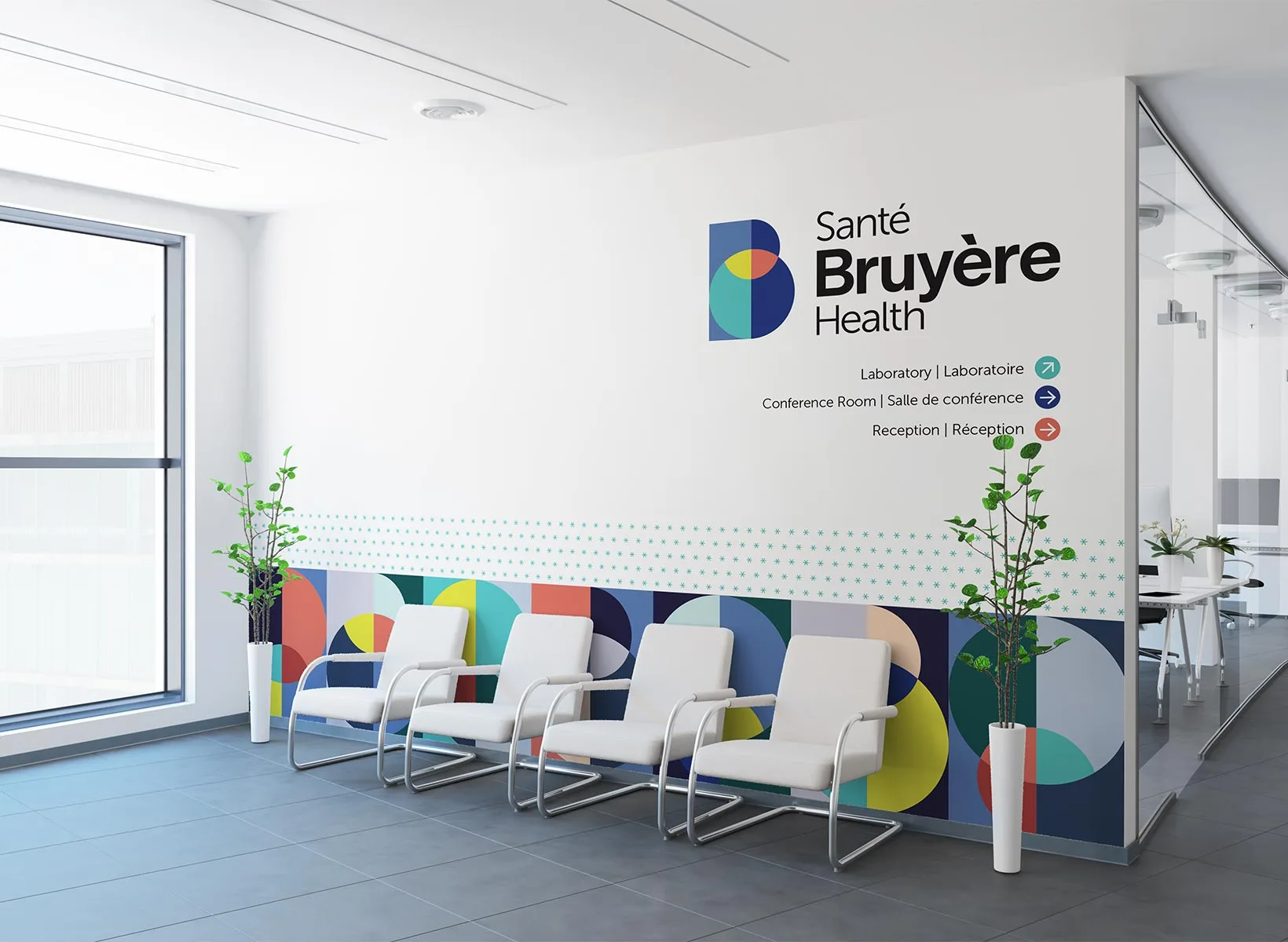 A modern waiting area with four white chairs, colorful geometric wall designs, two potted plants, and wayfinding signs for laboratory, conference room, and reception at Santé Bruyère Health.