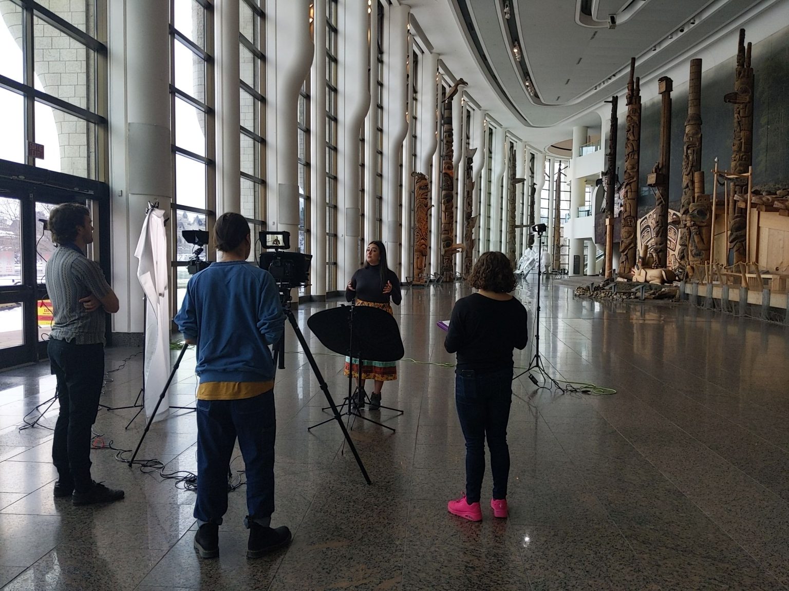 An interview and video production scene with one speaker and three technicians at the Canadian Museum of History