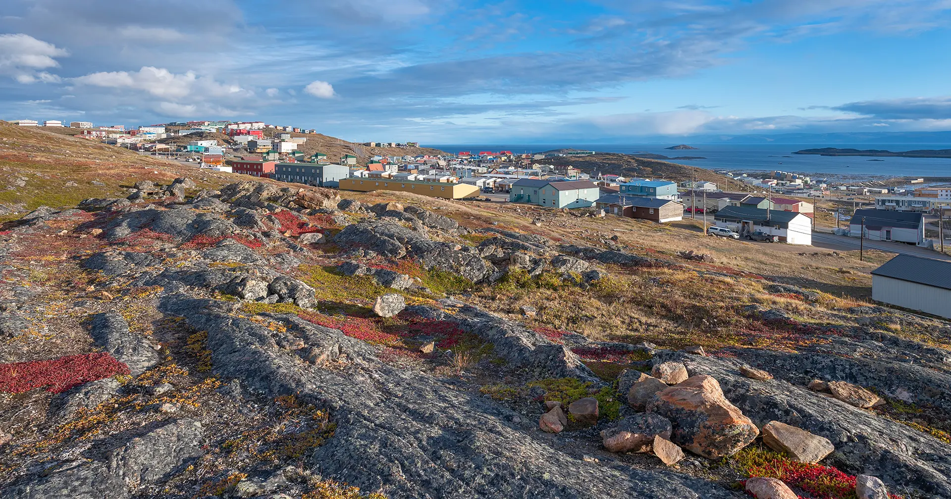 Overview of the city of Iqaluit with the Arctic Ocean harbor in the distance