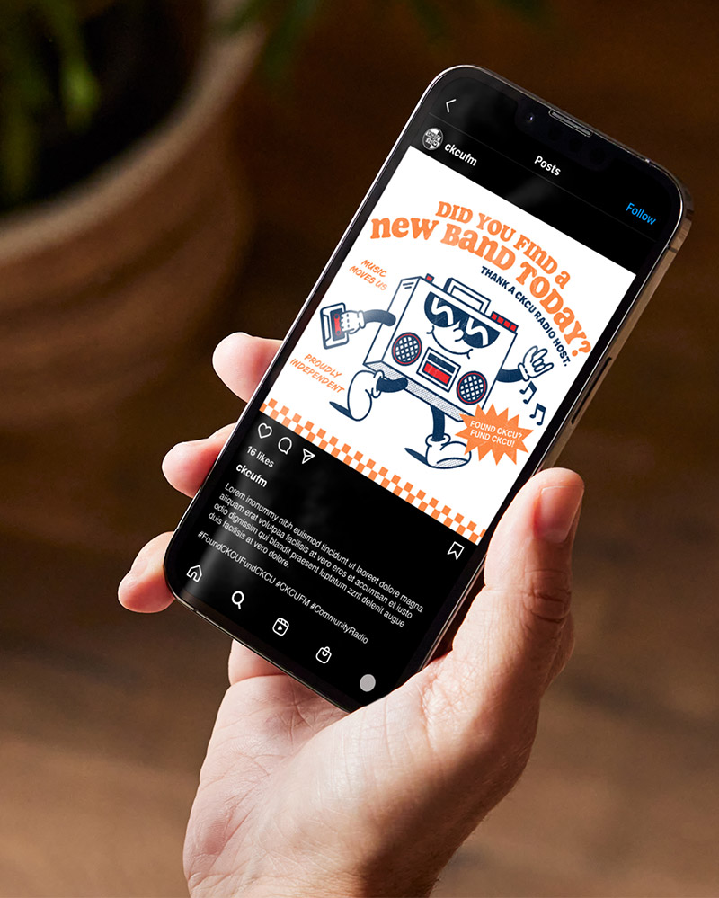 A hand holds a smartphone displaying an Instagram post featuring a cartoon boombox character with arms and legs, surrounded by playful text about discovering new bands. The phone screen is clear and vibrant.