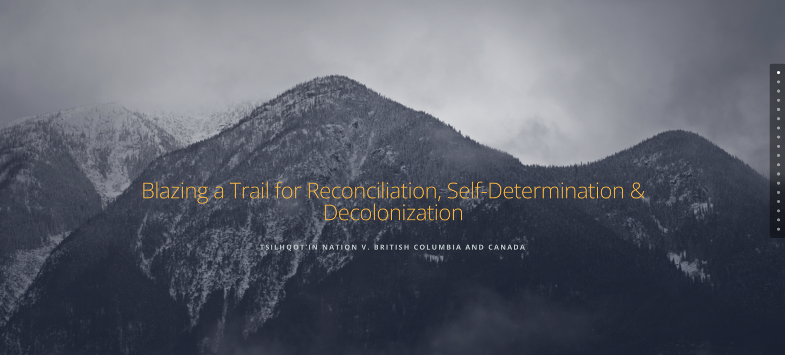 Snow-covered mountains under a cloudy sky with the text: “Blazing a Trail for Reconciliation, Self-Determination & Decolonization. Tsilhqot’in Nation v. British Columbia and Canada.”.